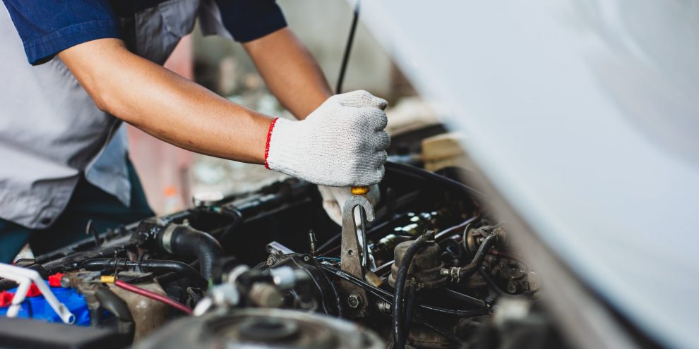 mechanic,uses,a,wrench,to,fix,the,car,engine.