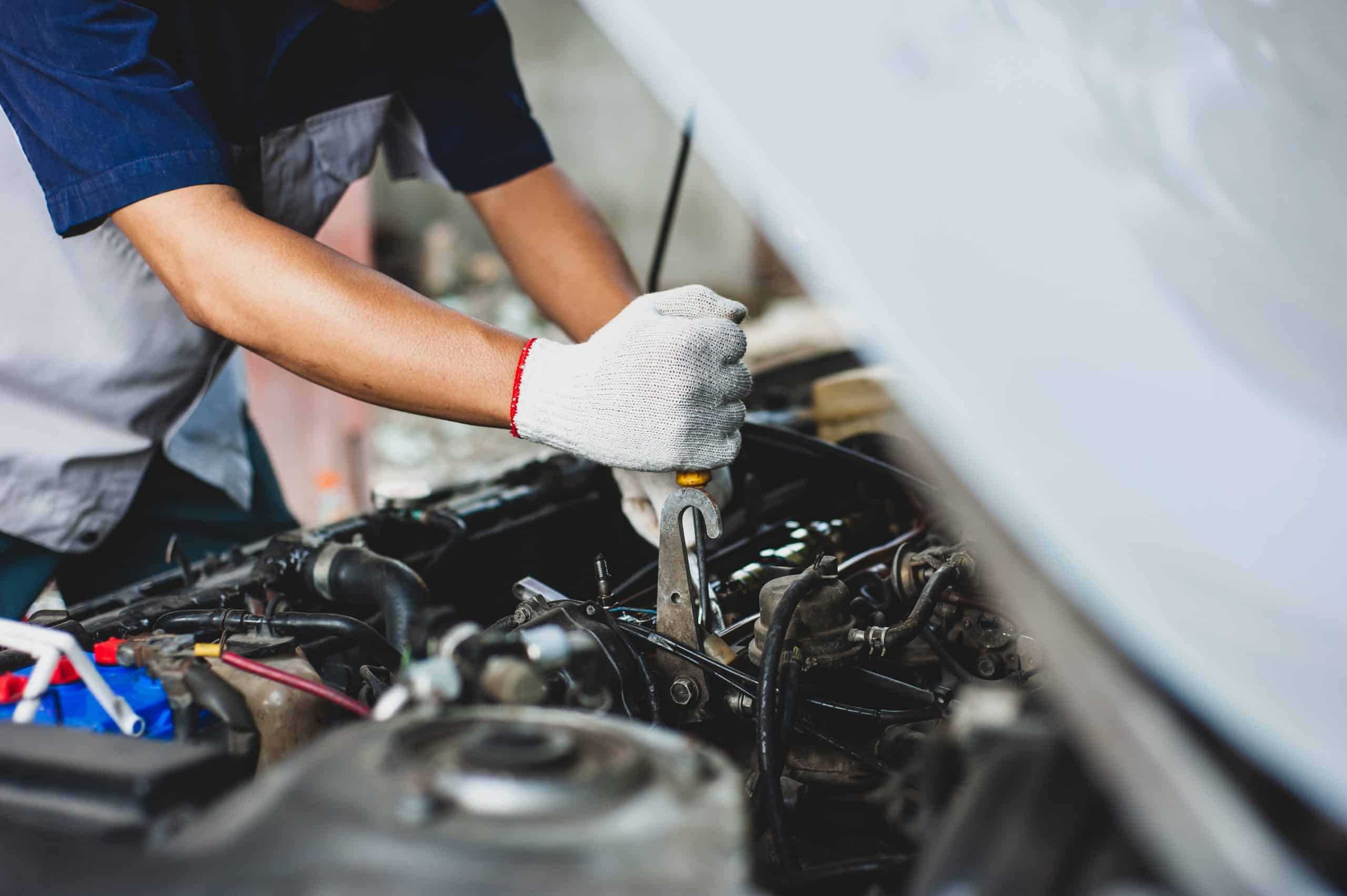 mechanic,uses,a,wrench,to,fix,the,car,engine.